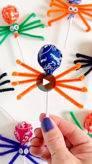 a person is holding up some lollipops in their hands and they are all made out of candy