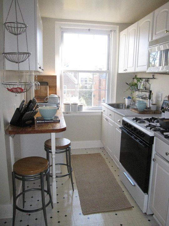 an image of a kitchen setting with white cabinets