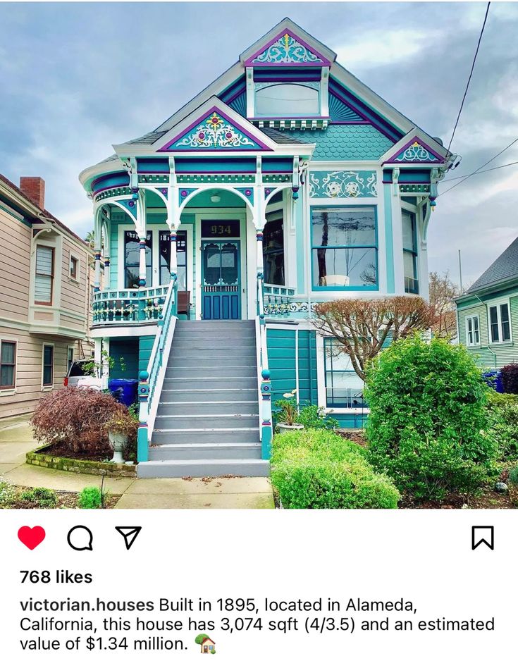 an old victorian house with blue trim and ornate details on the front porch, stairs leading up to the second floor