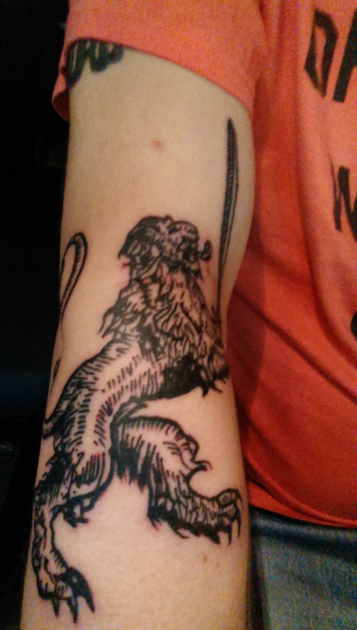 a man with a lion tattoo on his arm