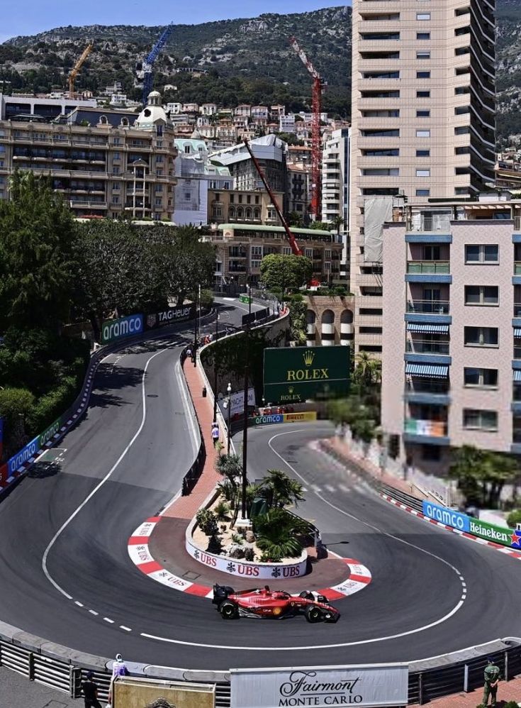 an aerial view of a race track with buildings in the background