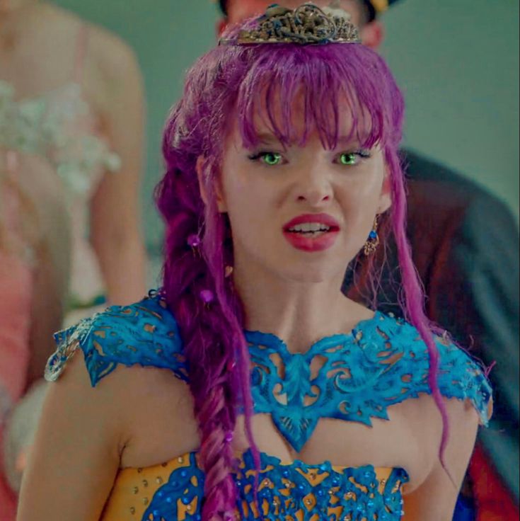 a woman with purple hair wearing a blue dress and crown on top of her head