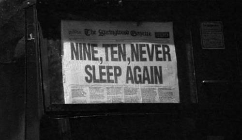 an old newspaper advertises nine, ten, never sleep again on the side of a building