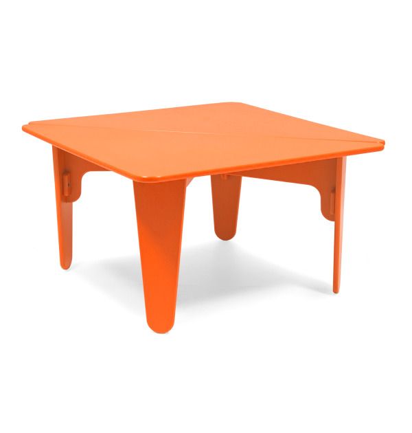 an orange plastic table sitting on top of a white floor