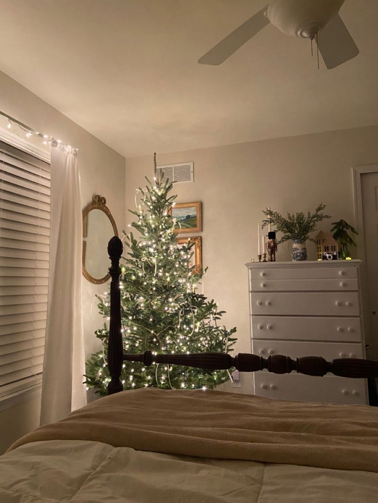 a bedroom with a christmas tree in the corner