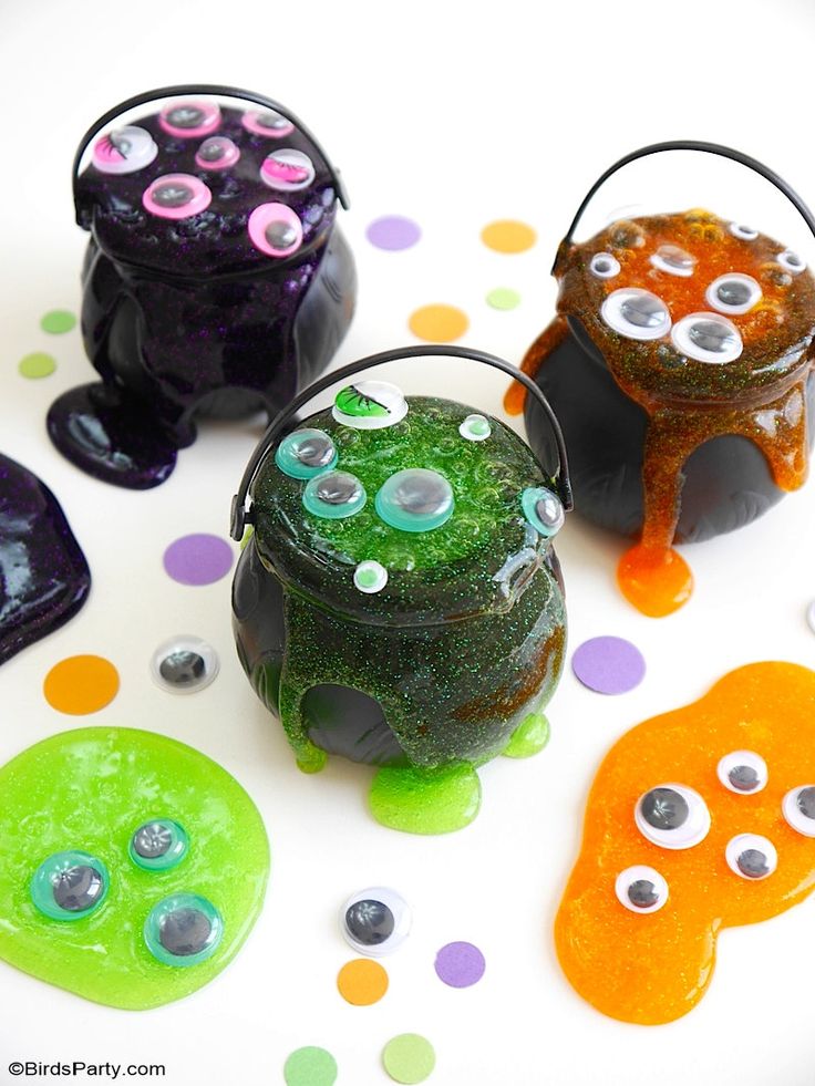 three halloween candy jars with googly eyes on them