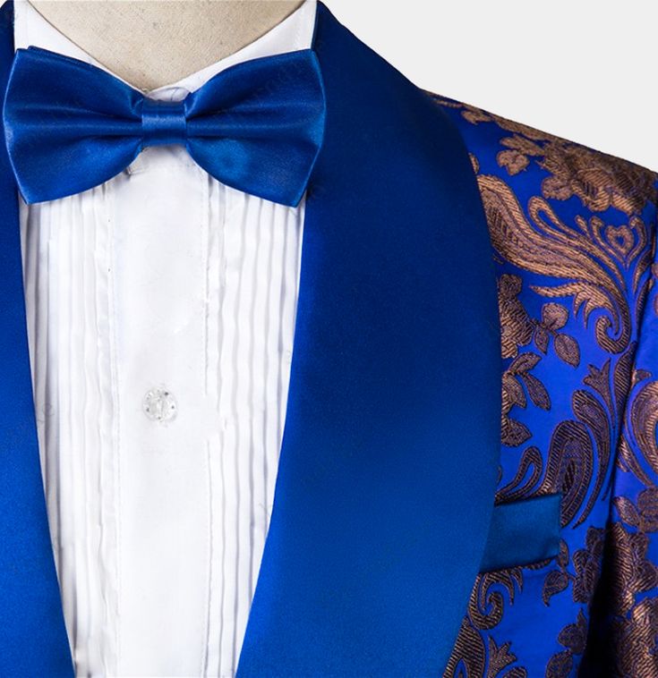 Turn some heads at your next formal event with this 3 pieces royal blue tuxedo. Take your formal wardrobe to the next level and indulge yourself with class, style, and sophistication when you add this tux to your collection. The royal blue hues gleam enticingly, while the golden embroidery gleams in a mischievous manner. The mix of blue and gold creates a mesmerizing effect that impresses right from the start. The pattern is a combination of floral and paisley motifs – the detailing is exquisite Elegant Tuxedo For Gala And Festive Occasions, Elegant Festive Suits For Gala, Elegant Festive Gala Suits, Elegant Gala Suits For Festive Season, Elegant Gala Suits For Festive Occasions, Festive Tuxedo Suit For Gala, Blue Tuxedo Three-piece Suit For Party, Blue Tuxedo Blazer For Wedding, Blue Tuxedo Blazer