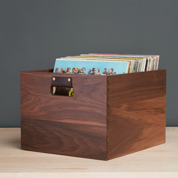 a wooden box with magazines in it on a table