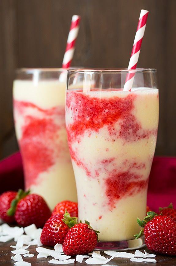 two glasses filled with yogurt and strawberries