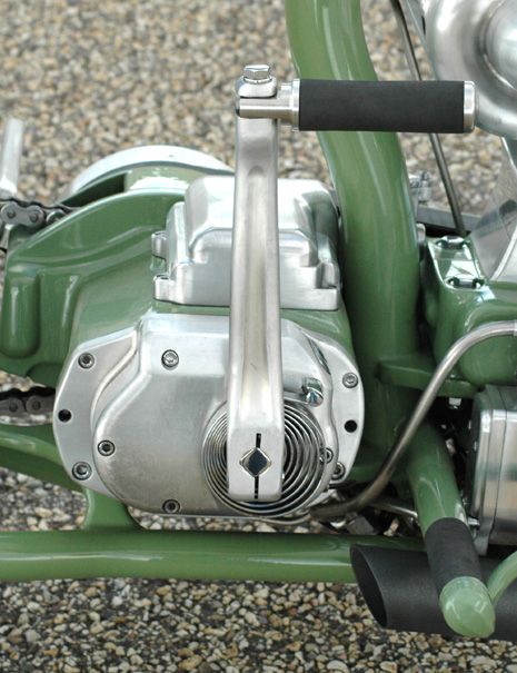 a close up view of the front end of a green motorcycle with its brake assembly missing