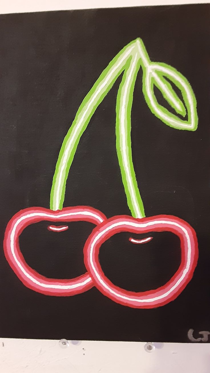 a chalk drawing of two cherries on a black board