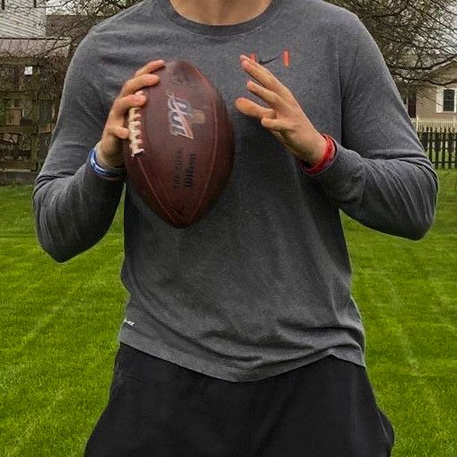 a man holding a football in his hands