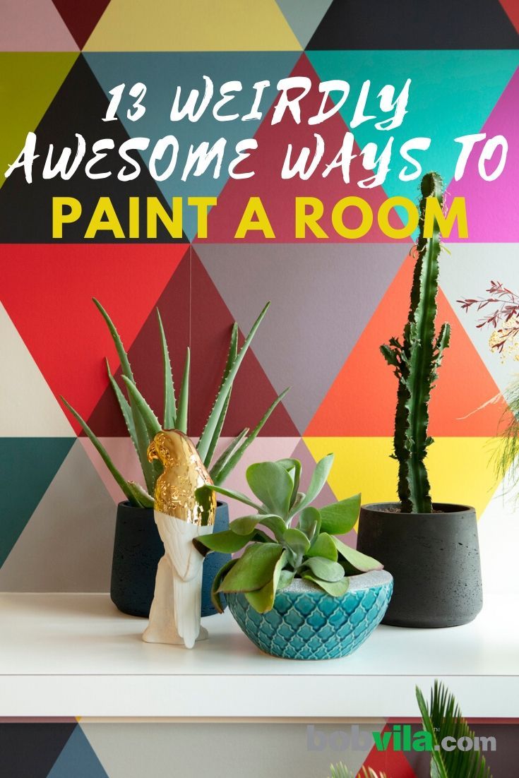 three potted plants sitting on top of a white shelf in front of a colorful wall