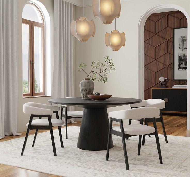 a dining room table with four chairs around it