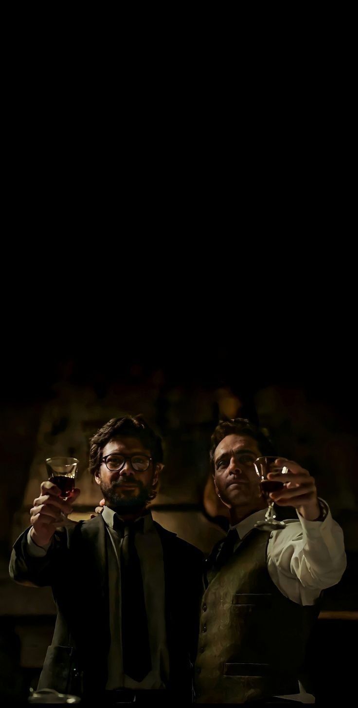 two men are holding wine glasses in their hands