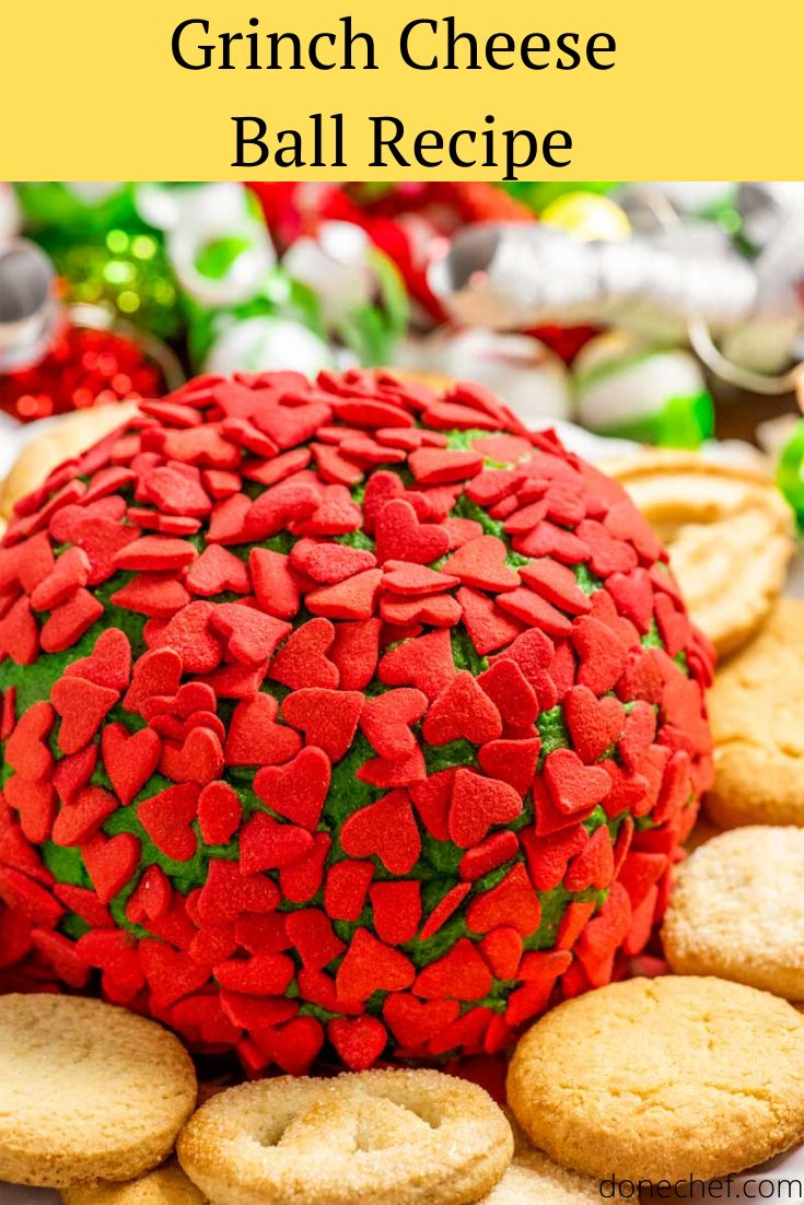 a large red ball covered in hearts on top of crackers next to other cookies