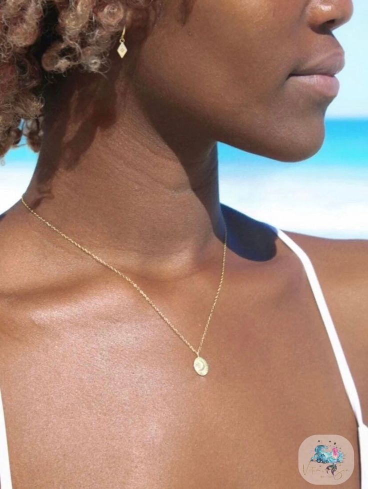 Delicate & dainty yet beautifully detailed. Where the moon meets the ocean, our Mahina necklace is a must-have! Live by the sun, love by the moon in our Mahina necklace. Adjust this necklace to a length that suits you, choose your own perfect look. Adjustable chain - adjust this necklace to a length that suits you Made with sterling silver & 18k gold vermeil - will never turn your skin green or tarnish Packaged in a gorgeous shell jewelry box- keep your jewelry stored beautifully 15-17” adjustab Minimalist Sterling Silver Necklace For Summer, Everyday Moon Phase Necklace, Dainty Round Jewelry For Beach, Yellow Gold Necklaces For Beach, Dainty Necklace With Delicate Chain For Beach, Elegant Yellow Gold Necklace For Beach, Dainty Beach Necklace With Delicate Chain, Elegant Yellow Gold Beach Necklace, Elegant Sun And Moon Design Necklace