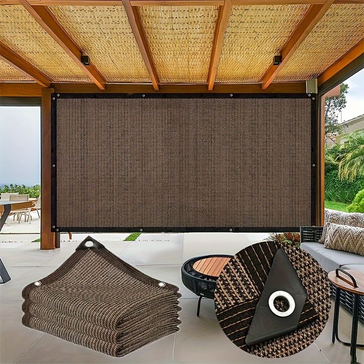 an outdoor covered patio area with wicker furniture and large shades on the windowsill