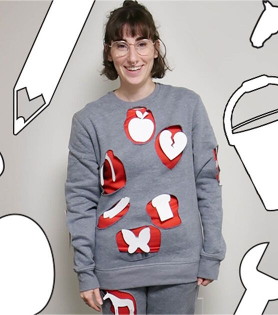 a woman standing in front of a wall with scissors and apples on it