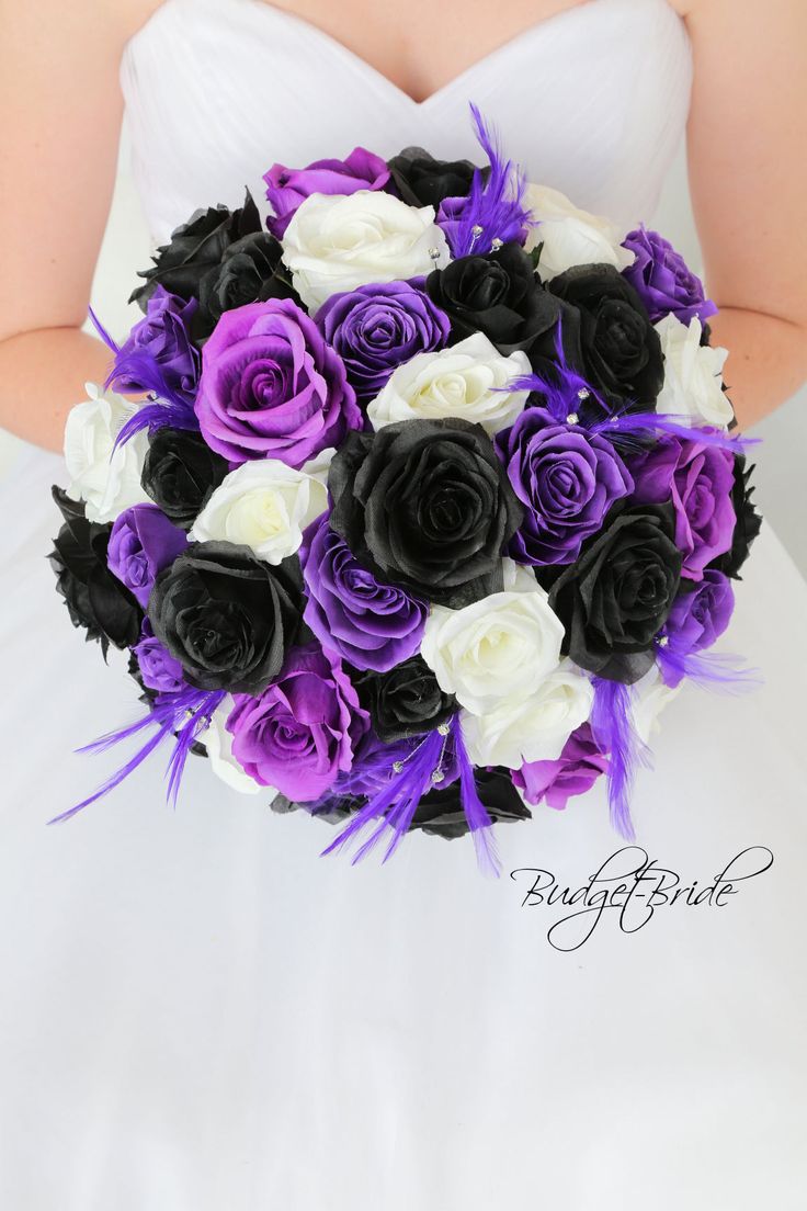 a bride holding a purple and white bouquet