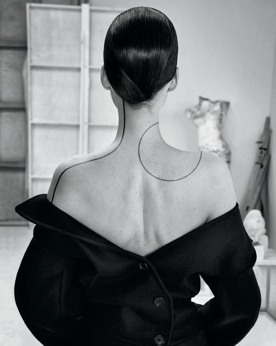 the back of a woman's head and shoulders, in black and white photo