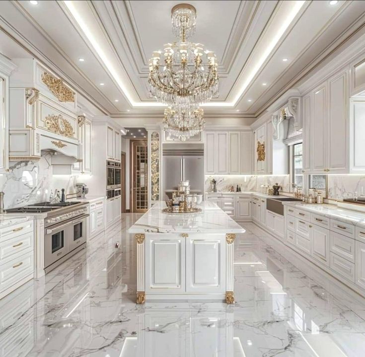 a large kitchen with marble counter tops and white cabinets, chandelier above the island