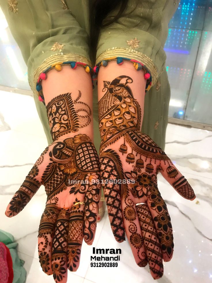 the hands are decorated with henna designs and beads on top of each hand,