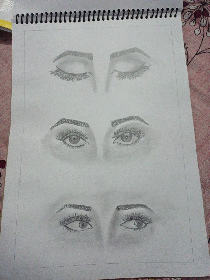 a drawing of four different eyes on paper