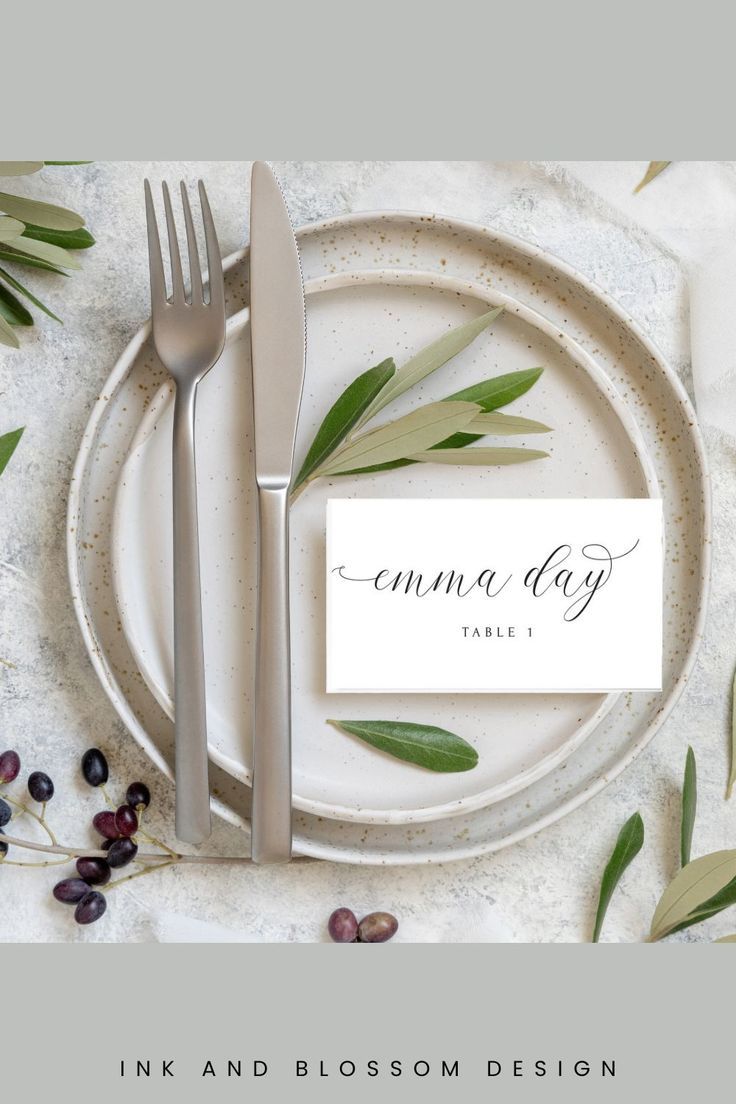 a table setting with place cards and silverware