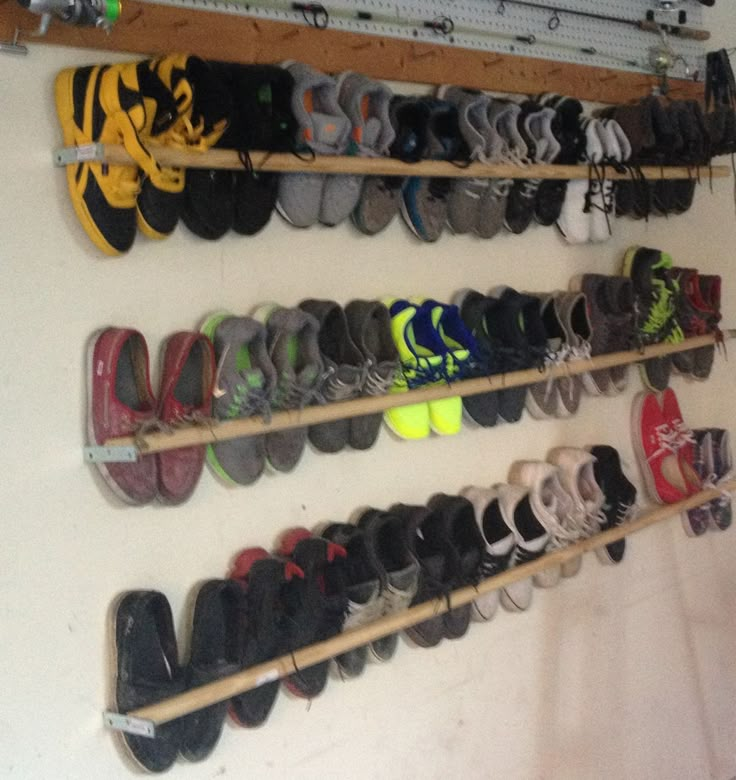 there are many pairs of shoes hanging on the wall