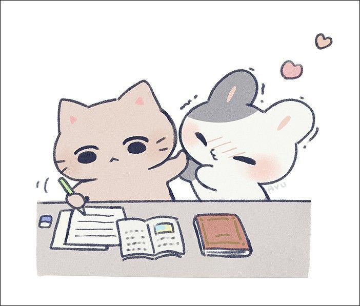 two cats are sitting at a desk with an open book and pen in front of them