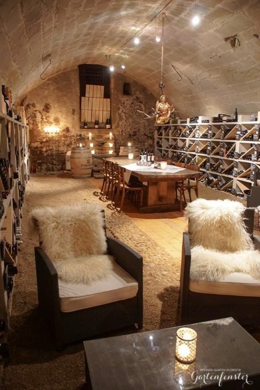 a wine cellar with two chairs and several bottles