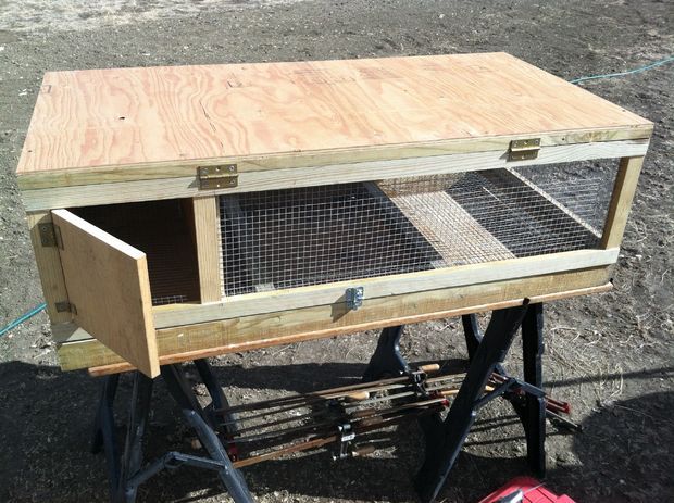 a large wooden bird cage sitting on top of a table