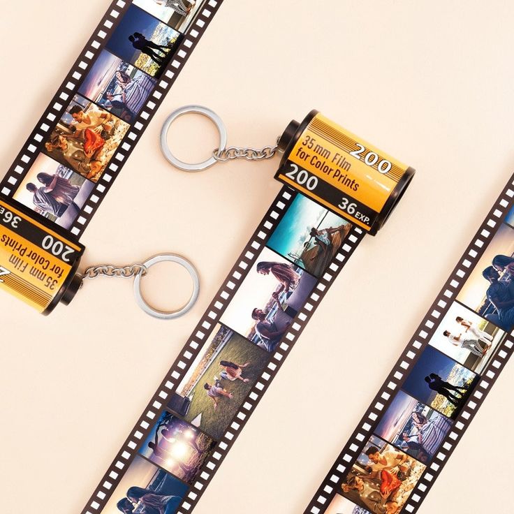 three film strip keychains with pictures on them