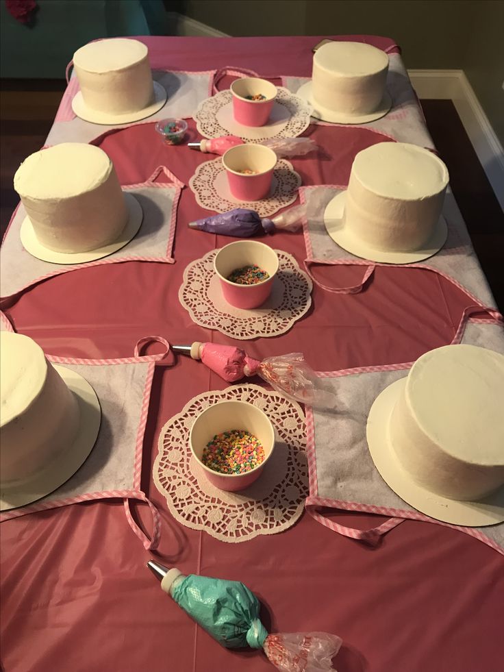 the table is set with many different types of hats and dishes on it, including one for cake