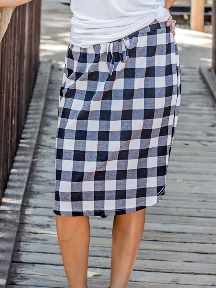 Looking for a weekend skirt that's both cozy and stylish? Look no further than our Buffalo Plaid Weekend Skirt! This skirt is the perfect combination of cute and comfortable, with a knee-length cut and a self-tie waistband that'll keep you feeling feminine and put-together all day long. Whether you're running errands or meeting up with friends for brunch, this skirt is sure to turn heads. And with sizing options ranging from S to 3X, it's easy to find the perfect fit for your body type.So why wa Cotton Skirt With Tie Waist For Day Out, Casual Tie Waist Skirt For Spring, Casual Spring Skirt With Tie Waist, Casual Tie Waist Skirt For A Day Out, Casual Skirt With Tie Waist For Spring, Casual Tie Waist Skirt For Vacation, Casual Pencil Skirt For Daywear, Casual Fall Vacation Skirt, Casual Knee-length Skirt With Tie Waist