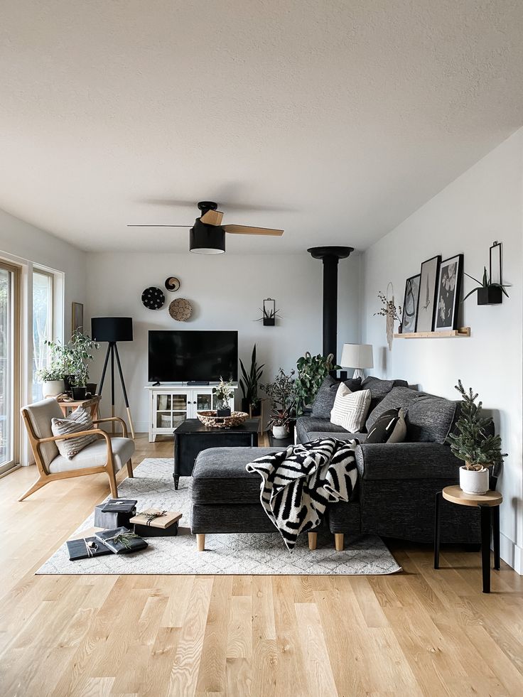 a living room filled with furniture and a flat screen tv on top of a wooden floor