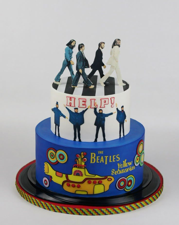 the beatles cake is decorated with figurines on it