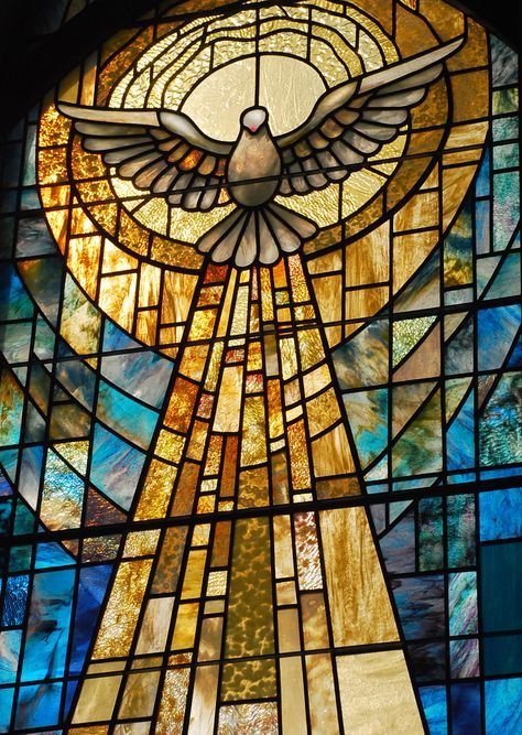 a large stained glass window with a dove on it's back and wings in the center