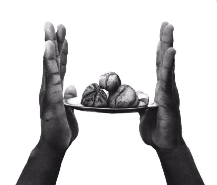 two hands holding a plate with food on it