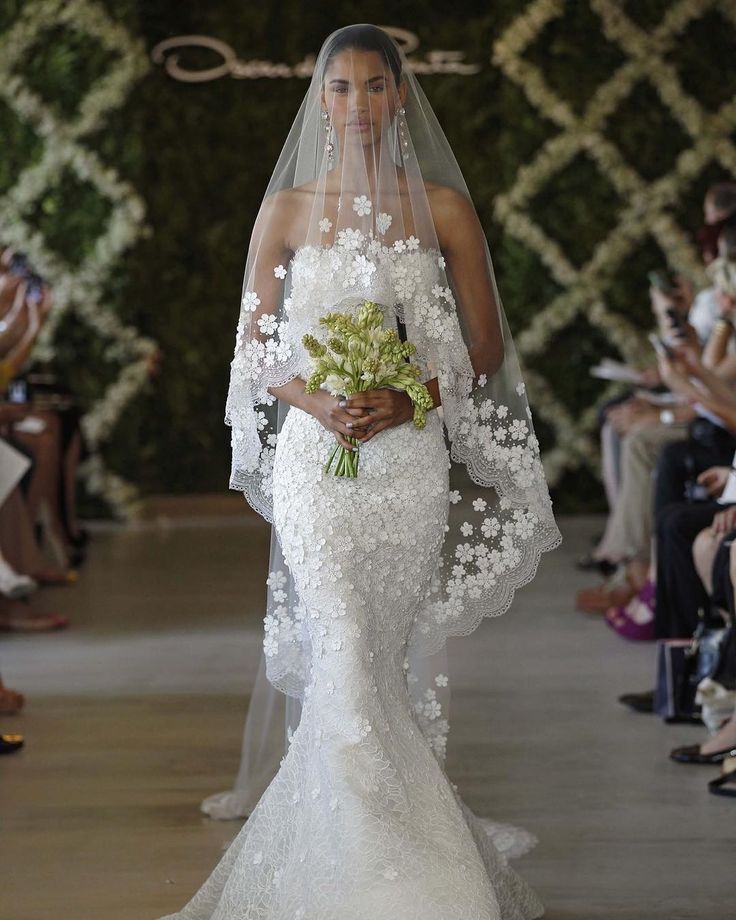 a woman in a white wedding dress and veil