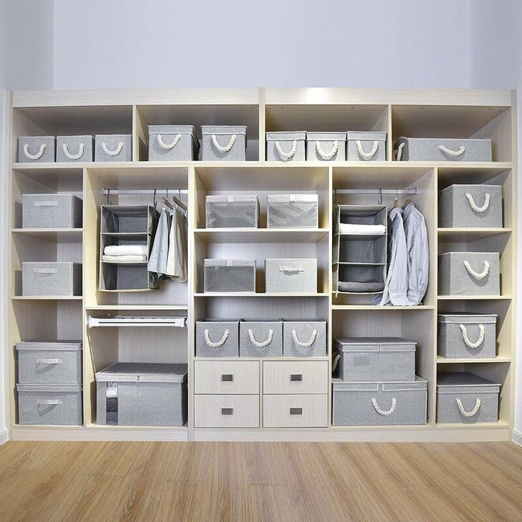 an organized closet with drawers and bins