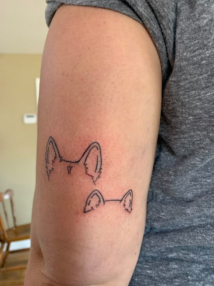 a woman with a tattoo on her arm that has a dog's face drawn on it