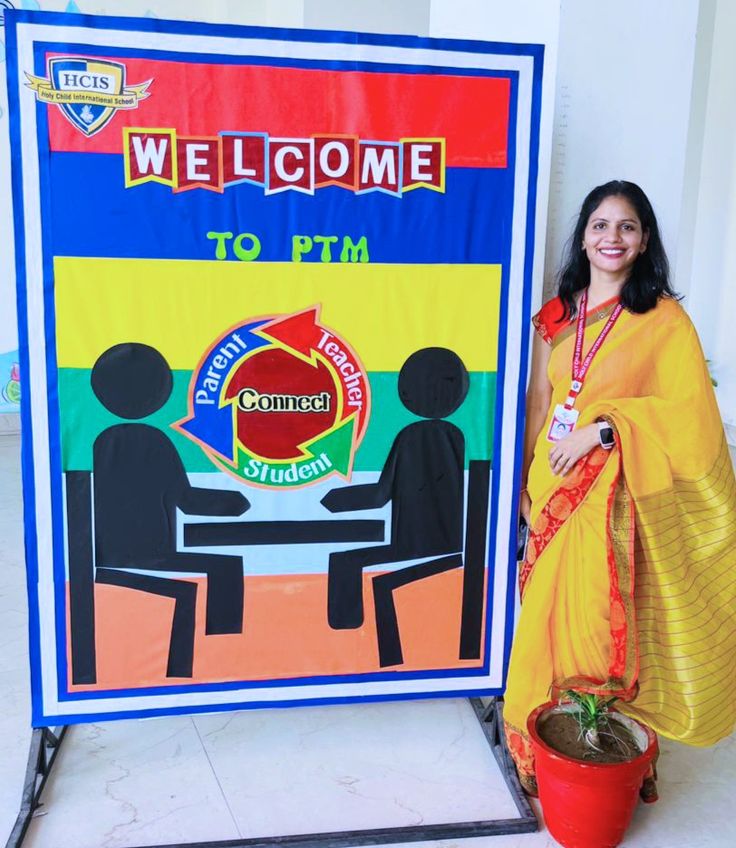 a woman standing next to a welcome sign