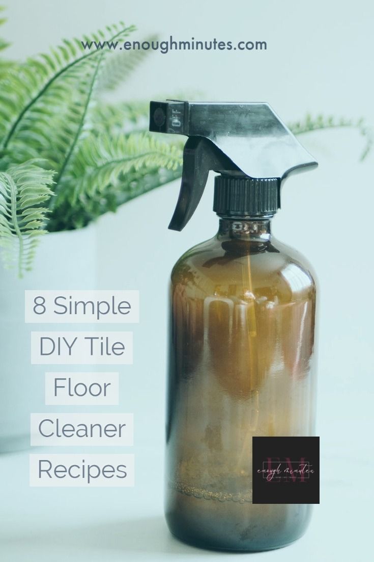 a spray bottle filled with brown liquid next to a potted plant