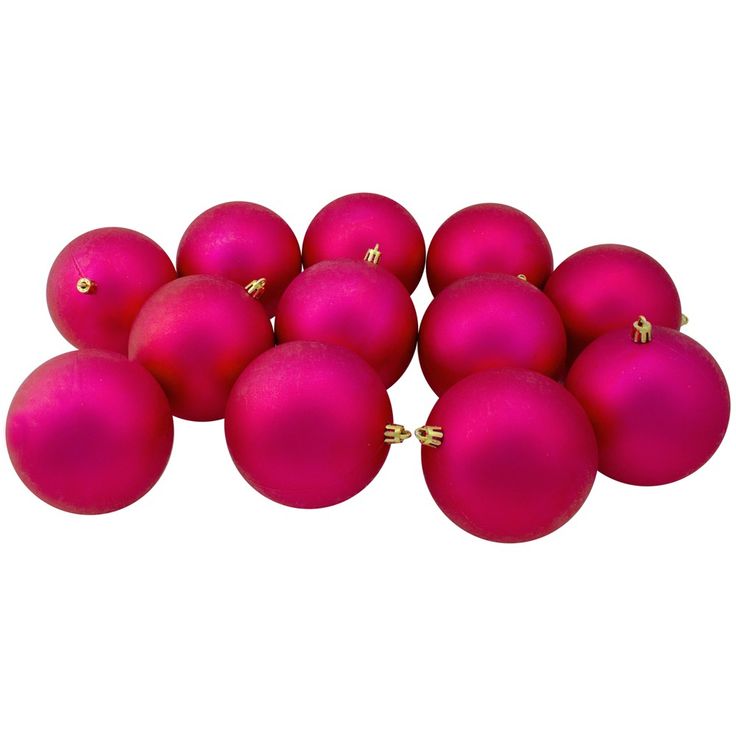 a pile of pink christmas balls on a white background