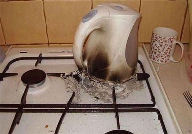 a tea kettle sitting on top of a stove with water coming out of the pot