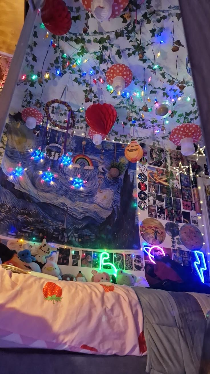 a child's bedroom decorated with colorful lights and pictures on the wall above it