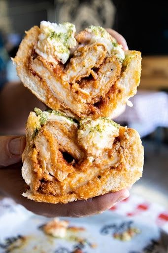 two fried food items being held up in the air