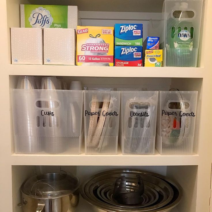 an organized pantry with plastic containers and other items